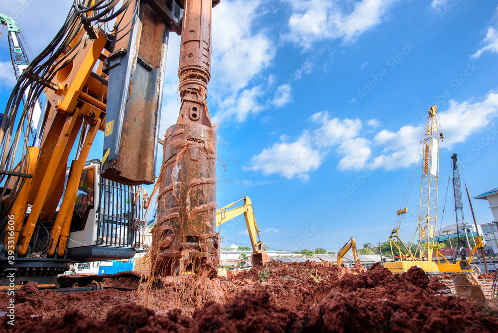 Earth drilling machine or hydraulic boring machine into a construction site for drilling piles. - obrazy, fototapety, plakaty 