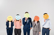 © LIGHTFIELD STUDIOS - Multiethnic businesspeople holding cards with emotions isolated on grey