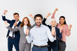 © LIGHTFIELD STUDIOS - Positive businessman showing yeah gesture near multiethnic colleagues on blurred background isolated on grey