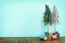 Image Of Christmas Tree With Decorations In Front Of Pastel Blue Background