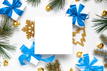 gift ribbon box. white gift box with blue ribbon, new year balls and christmas tree in xmas composit