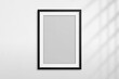 © Omeris - Mockup black frame photo. Shadow on wall. Mock up artwork picture framed. Vertical boarder. Empty board a4 photoframe. Modern stylish 3d border for design prints poster, blank, painting image. Vector