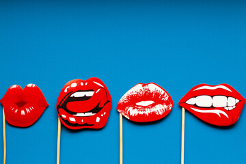 different shapes of female red juicy sexy lips on a blue solid background