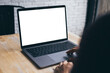 © panitan - computer blank screen mockup.hand woman work using laptop with white background for advertising,contact business search information on desk at coffee shop.marketing and creative design