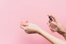 Cropped View Of Woman Holding Bottle With Luxury Perfume Isolated On Pink