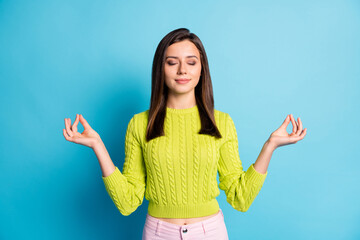 Sticker - Photo of young beautiful peaceful positive happy girl woman female meditating hold hands balance isolated on blue color background