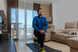 © expressiovisual - Latin man, doing a workout in his living room.