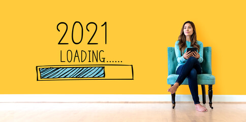 Wall Mural - Loading new year 2021 with young woman holding a tablet computer