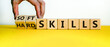 © Dzmitry - Hard skills versus soft skills. Hand flips cubes and changes the expression 'hard skills' to 'soft skills' or vice versa. Beautiful yellow table, white background. Business concept. Copy space.
