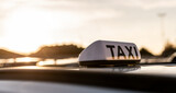Fototapeta  - Taxi sign during the sunset
