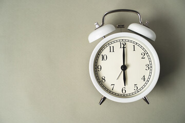 Wall Mural - alarm clock with a dial lies on a gray background, business idea, time is money