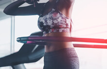 Sporty Woman Is Exercising With Hula Hoop In Fitness Gym For Healthy Lifestyle Concept.
