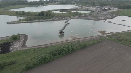 Wall Mural - drone footage of grovel mining machinery on lake extracting gravel