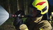 © CameraCraft - Portrait shot of the firefighter spraying fire with the hose. Close up. High quality photo