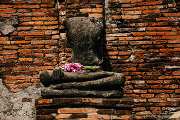 Broken Buddha statue at Ayutthaya historical park of Wat Mahathat.