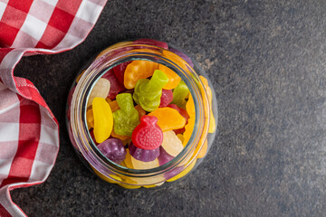 Colorful fruity jelly candies in jar.