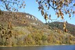 © ummanandapics - Happurger Stausee water reservoir with hills, colorful forest and rocks on a sunny autumn day