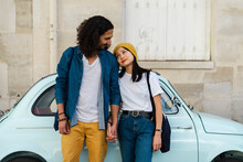 Young Couple In Love Standing At Small Car