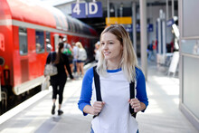 Portrait Of Blond Woman With Backpack On Platform