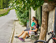 © Christian Vorhofer/Westend61 - Couple with mountain bikes resting on a bench