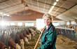 © Christian Vorhofer/Westend61 - Portrait of smiling female farmer in stable on a farm