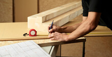 Worker Marking Wood With Pencil, Tape Measure