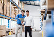 © Daniel Ingold/Westend61 - Two businessmen having a meeting in company warehouse
