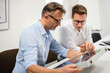 © Daniel Ingold/Westend61 - Two businessmen examining solar panel on desk in office