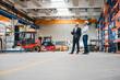 © Daniel Ingold/Westend61 - Two men wearing hard hats in factory shop floor