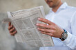 © Daniel Ingold/Westend61 - Close-up of businessman reading newspaper