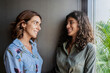 © Javier De La Torre Sebastian/Westend61 - Mother and daughter talking while leaning on wall at home