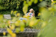 © Joseffson/Westend61 - Young woman relaxing on jetty in garden