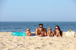 © New Africa - Happy family on sandy beach near sea. Summer holidays