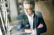 © Joseffson/Westend61 - Serious mature businessman looking out of window