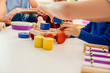 © Mareen Fischinger, Photographer/Westend61 - Close-up of children playing with musical instruments and toys in kindergarten