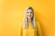 © Robijn Page/Westend61 - Portrait of smiling woman at yellow wall