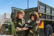 © Mikel Taboada/Westend61 - Multi-ethnic female army soldiers discussing over digital tablet at military base on sunny day