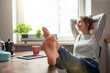 © philipp@nemenz.de/Westend61 - Woman sitting at table in kitchen relaxing