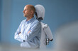 © MAGIC UNICORN/Westend61 - Businessman standing back to back with robot