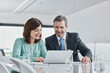© Roger Richter/Westend61 - Businessman and businesswoman having a meeting in office with laptop