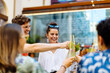 © Sofie Delauw/Westend61 - Happy multi-ethnic friends toasting drinks
