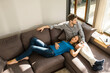 © steve brookland/Westend61 - Affectionate couple relaxing on sofa at home