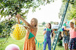 © Sofie Delauw/Westend61 - Girls decorating the garden for a birthday party
