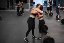 Athletes Hugging Each Other While Standing At Gym
