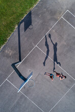 Young Man And Woman Playing Basketball, Aerial View