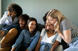 © VALENTINA BARRETO PHOTOGRAPHY/Westend61 - Playful friends sitting on couch