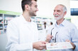 © Pavel Horak/Westend61 - Pharmacist smiling at mature man in pharmacy