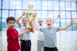 © Pavel Horak/Westend61 - Happy pupils holding trophy in gym