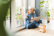 © UWE_UMSTAETTER/Westend61 - Mature woman drinking juice while working on digital tablet at home
