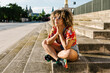 © Xavier Lorenzo/Westend61 - Thoughtful trendy woman sitting on steps in city